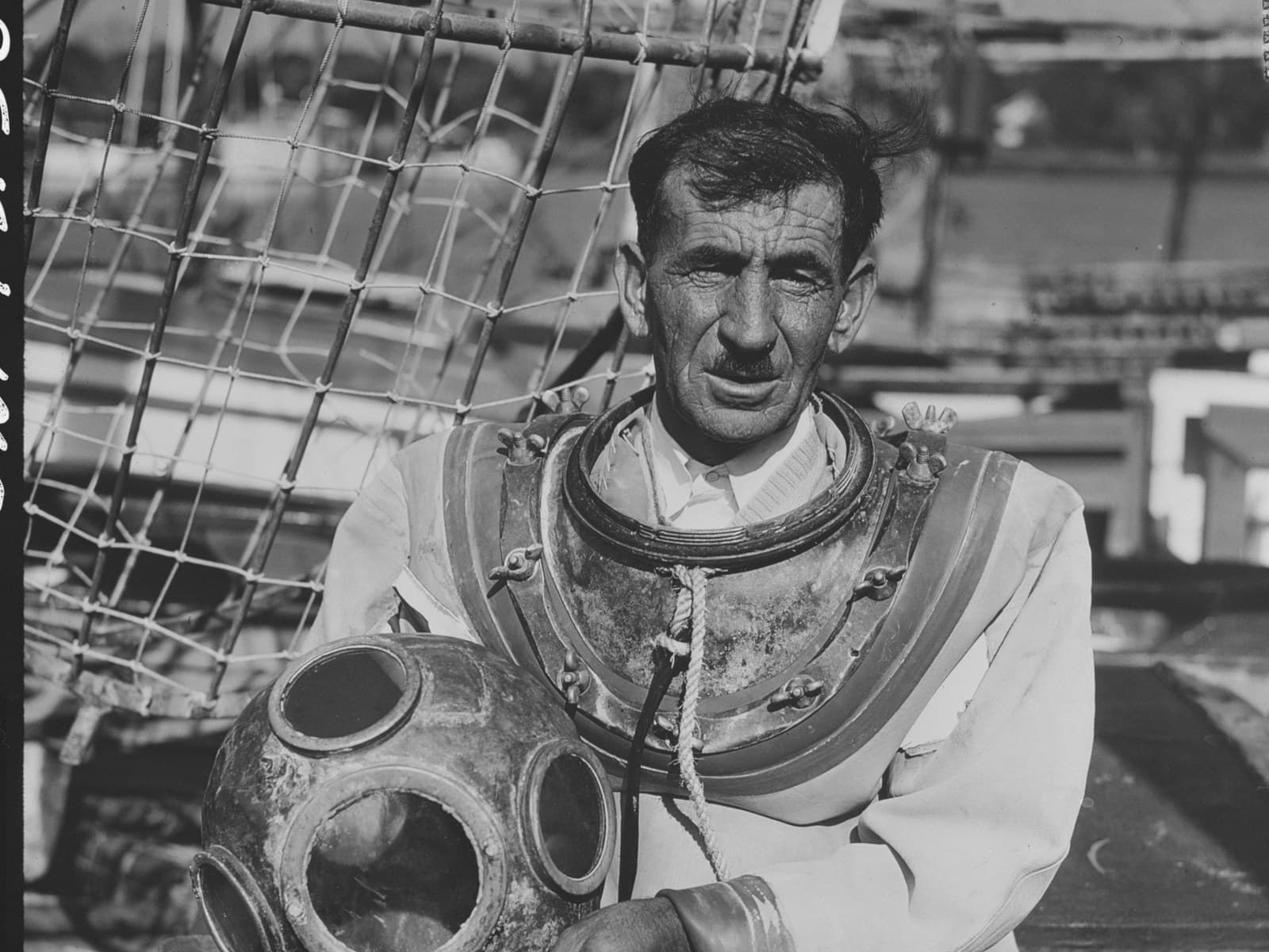 A sponge diver on deck with his helmet at Tarpon Springs, January 1944, photographed on Kodachrome for the Office of War Information