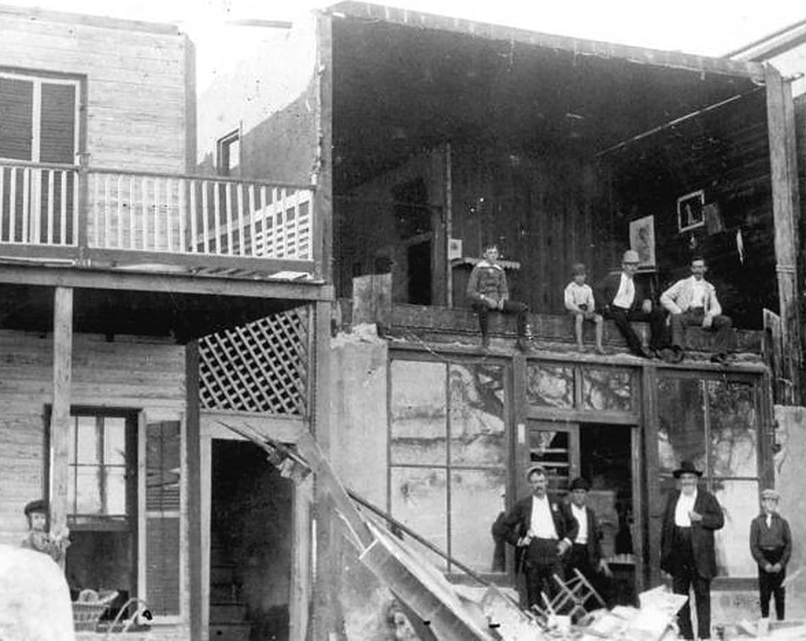 Townspeople beside a wrecked building after the hurricane of September 29, 1896
